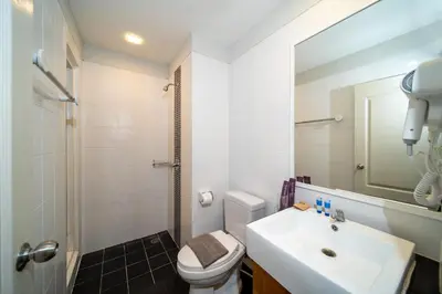 a bathroom with a sink and a toilet and a mirror at Catnip Seaside Hotel&Cafe in Ban Huai Luk (1)