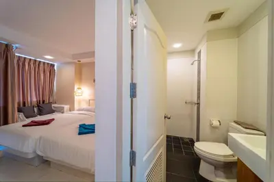 a bathroom with a bed and a toilet and a sink at Catnip Seaside Hotel&Cafe in Ban Huai Luk (1)
