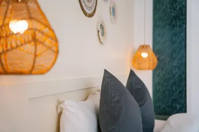 a bedroom with a bed with pillows on it at Catnip Seaside Hotel&Cafe in Ban Huai Luk (1)