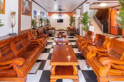 a row of wooden benches in a waiting room at Sunshine Patong in Patong Beach