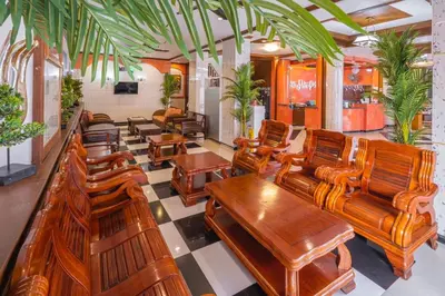 a room filled with wooden chairs and tables at Sunshine Patong in Patong Beach