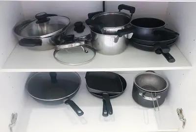three pots and pans on a shelf in a kitchen at Beachfront 2br home with private plunge pool on stunning Naithon beach 3 in Nai Thon Beach