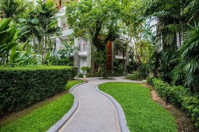a walkway in front of a building with palm trees at Beachfront 2br home with private plunge pool on stunning Naithon beach 3 in Nai Thon Beach