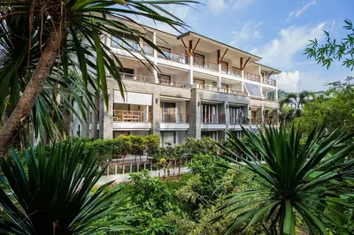 an apartment building with plants in front of it at Beachfront 2br home with private plunge pool on stunning Naithon beach 3 in Nai Thon Beach