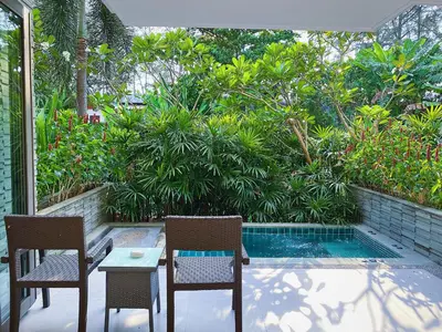 a patio with two chairs and a table and a pool at Beachfront 2br home with private plunge pool on stunning Naithon beach 3 in Nai Thon Beach