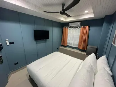 a bedroom with a bed and a flat screen tv at Sari Boutique hotel in Patong Beach