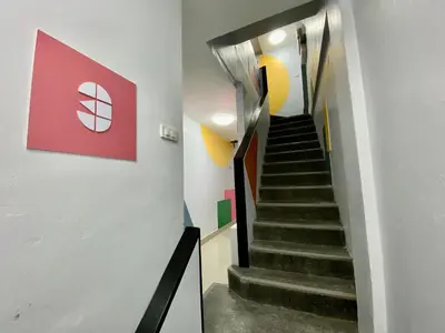 a staircase in a building with a red sign on the wall at Sari Boutique hotel in Patong Beach