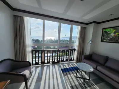 a living room with a couch and a balcony at Andaman sea view private in Patong Beach