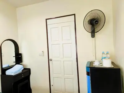 a room with a white door and a fan at Nu Phuket Airport Resident 1 in Nai Yang Beach