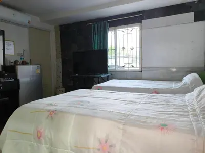a bedroom with a large bed and a television at Nu Phuket Airport Resident 1 in Nai Yang Beach