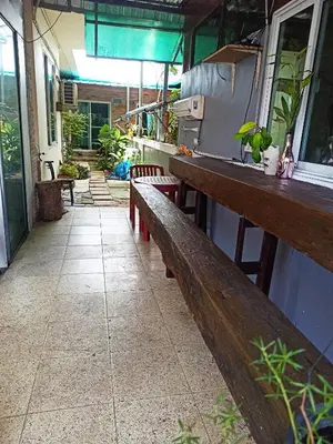 a row of benches sitting outside of a building at Nu Phuket Airport Resident 1 in Nai Yang Beach