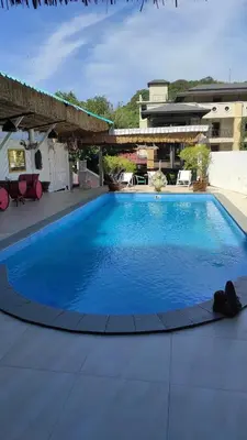a large blue swimming pool on top of a building at Baan sikhao Yanui in Rawai Beach