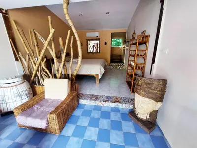 a room with a bed and a blue tile floor at Baan sikhao Yanui in Rawai Beach