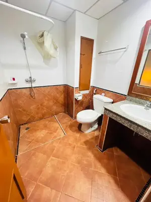 a bathroom with a toilet and a sink at Royal Vista Patong in Patong Beach