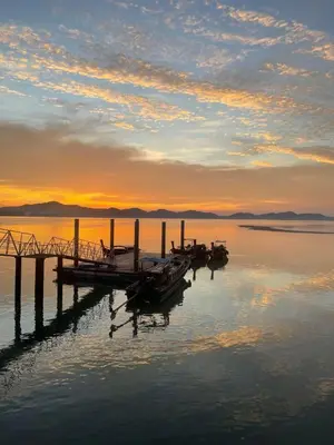 a group of boats in the water at sunset at Hunny Home in Ko Yao Noi