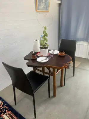 a wooden table with chairs and a plant on it at Hunny Home in Ko Yao Noi