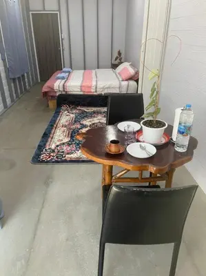 a table and chair with a bed in a room at Hunny Home in Ko Yao Noi