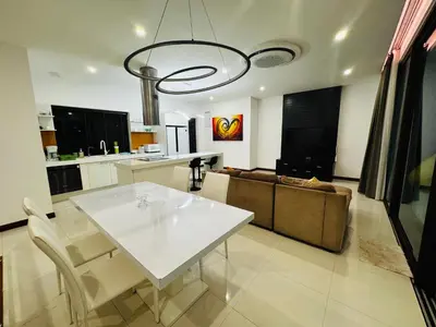 a living room with a white table and a couch at Sunrise Villa 21 in Phuket Town