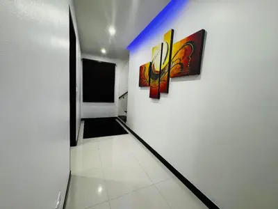 a hallway with three paintings on a wall at Sunrise Villa 21 in Phuket Town