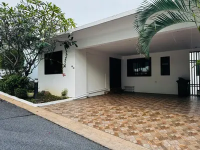 a white building with a brick parking lot at Sunrise Villa 21 in Phuket Town
