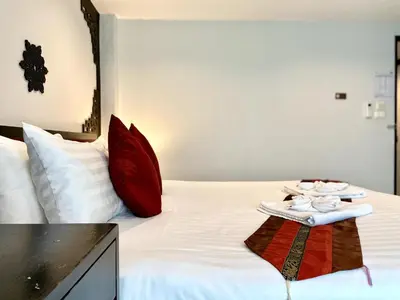 a hotel room with a bed with a tray of towels at Sunray Beach Hotel Patong in Patong Beach