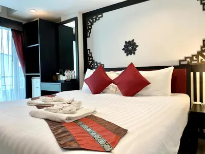 a bedroom with a bed with towels on it at Sunray Beach Hotel Patong in Patong Beach