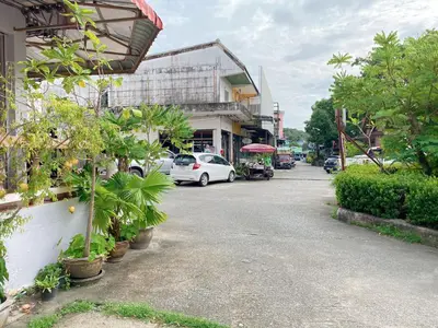 a street with a white car parked on the street at 2 Vikings Guesthouse in Karon Beach
