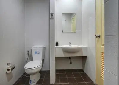a bathroom with a toilet and a sink at Kata Beach Guesthouse in Kata Beach