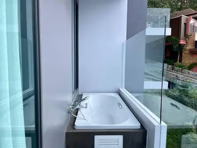 a bathroom with a sink and a glass window at A402-Silk Condo Aonang-Sea view-5 mins walk to beach in Ao Nang Beach