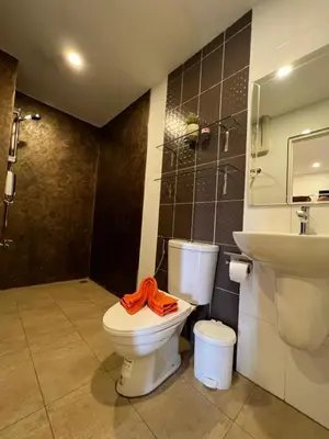 a bathroom with a toilet and a sink at Super Som Rawai in Rawai Beach