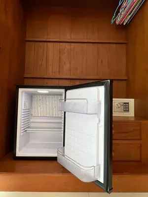 an empty refrigerator with its door open in a kitchen at Super Som Rawai in Rawai Beach