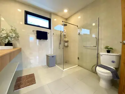 a bathroom with a shower and a toilet and a sink at Kamala - Chonlada Holiday Home 2 BR Residence in Kamala Beach