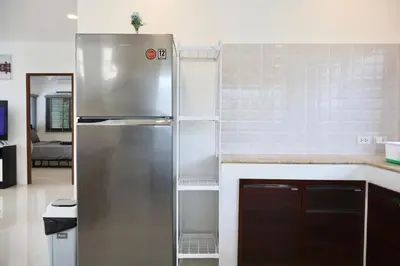 a stainless steel refrigerator in a kitchen at Kamala - Chonlada Holiday Home 2 BR Residence in Kamala Beach