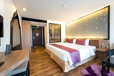 a bedroom with a large bed and a desk at The Beach Heights Condotel Kata 500 meters to Kata beach in Kata Beach