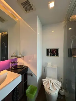 a bathroom with a white toilet and a sink at The Beach Heights Condotel Kata 500 meters to Kata beach in Kata Beach