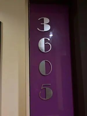 a purple sign with the words bds on a wall at The Beach Heights Condotel Kata 500 meters to Kata beach in Kata Beach
