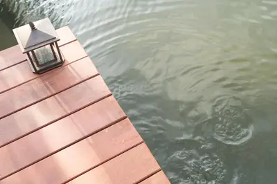 a lamp sitting on the end of a dock in the water at Anodard Phuket, Nai Yang Beach in Thalang