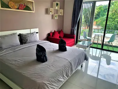 a bedroom with a bed with two black bags on it at Pixel Condo - Panwa Beach in Ban Ao Makham