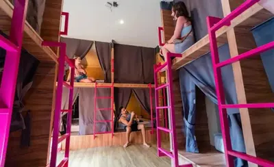a group of people in a pink bunk bed at Slumber Surf Phuket Kata in Kata Beach