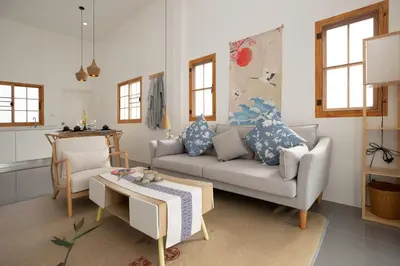 a living room with a couch and a table at Villa Sunrise Garden A180 in Thalang
