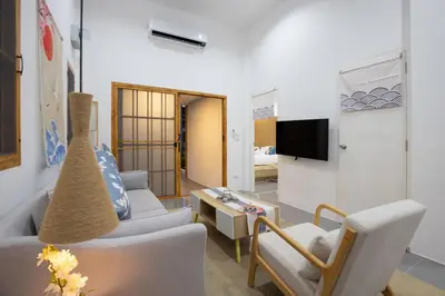 a living room with a couch and chairs and a tv at Villa Sunrise Garden A180 in Thalang
