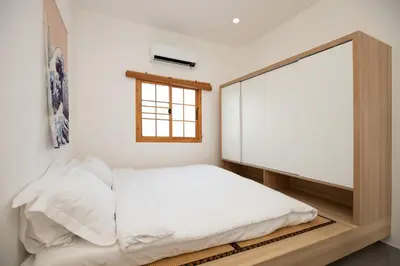 a bedroom with a bed with a large mirror at Villa Sunrise Garden A180 in Thalang