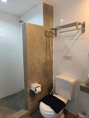 a bathroom with a toilet and a shower at Noble House Patong in Patong Beach