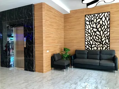 a lobby with a couch and two chairs at I AM O'TEL Patong in Patong Beach