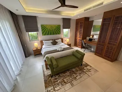 a large bedroom with a bed and a green couch at Villa Jasmine - luxury private villa Bangtao Beach in Bang Tao Beach