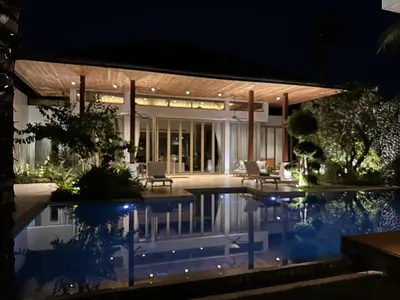 a house with a swimming pool at night at Villa Jasmine - luxury private villa Bangtao Beach in Bang Tao Beach