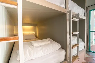 a bedroom with two bunk beds in a room at Nomads Ao Nang Party Hostel 18-35 Years Old Only in Ao Nang Beach