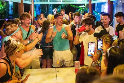 a group of people standing around in a crowd at Nomads Ao Nang Party Hostel 18-35 Years Old Only in Ao Nang Beach