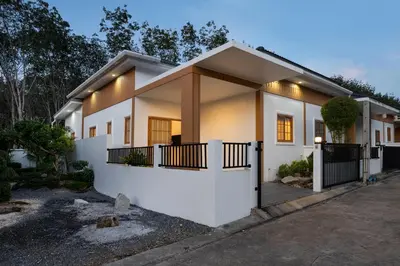 a house with white walls and a fence at Villa Sunrise Garden B190 in Thalang