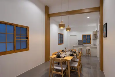 a kitchen and dining room with a table and chairs at Villa Sunrise Garden B190 in Thalang